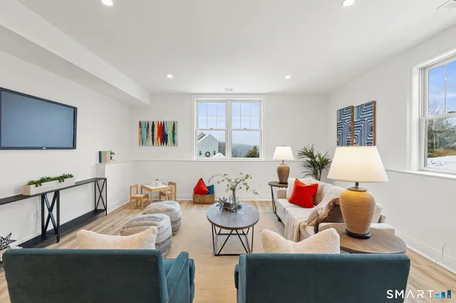 a bathroom with a bathtub shower sink vanity and toilet