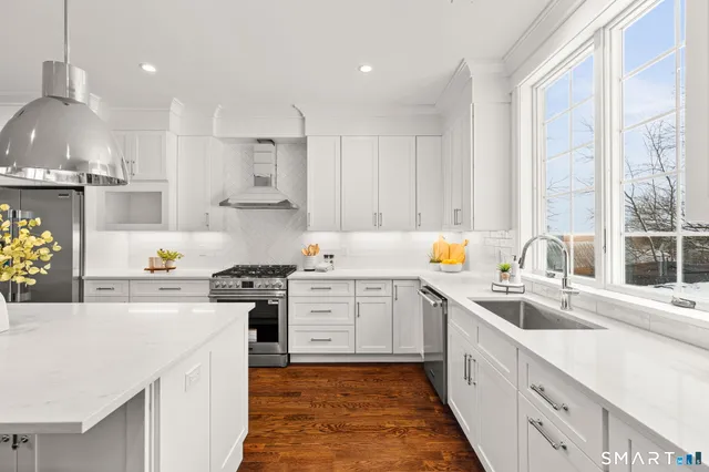 a kitchen with a sink stove and cabinets