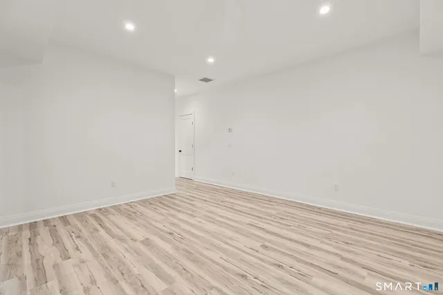 a bathroom with a granite countertop sink mirror vanity and toilet