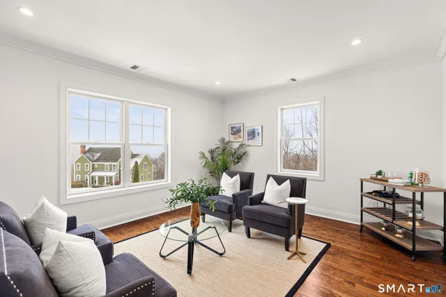 a view of a dining room with furniture window and wooden floor