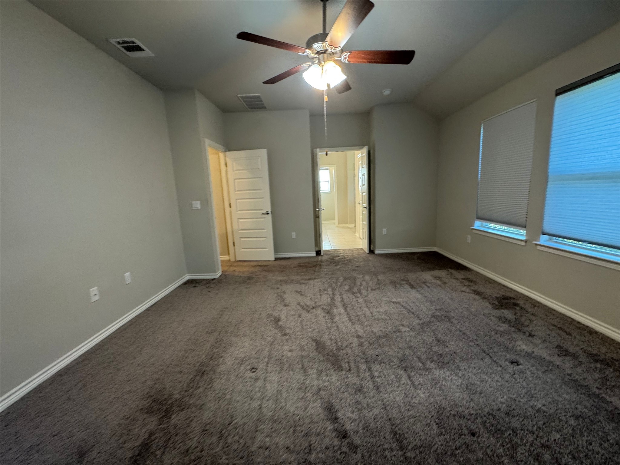 14100 McCoy Loop, Unit 1 Austin, TX 78717 - Photo 18 of 39 A spacious, naturally illuminated room features plush carpeting and convenient interior access.