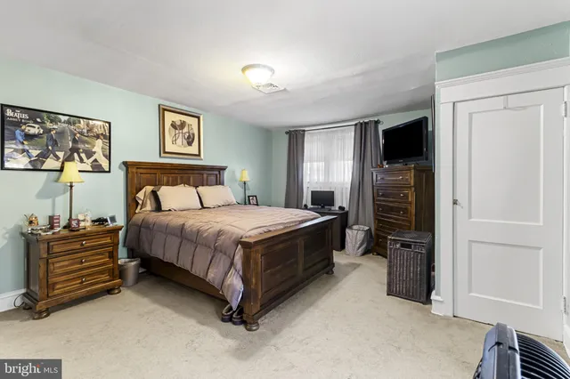 a bedroom with a bed and a television