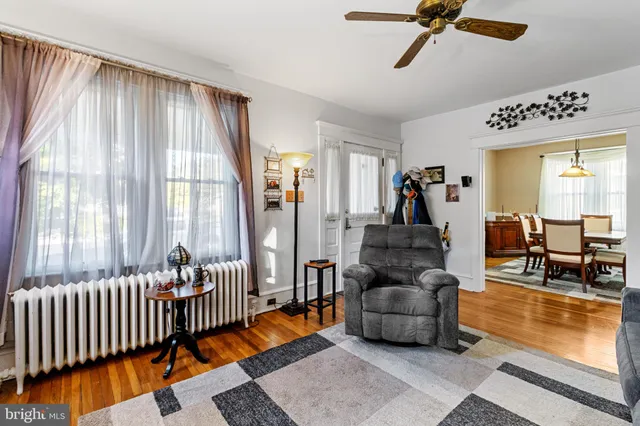 a living room with furniture and floor to ceiling windows