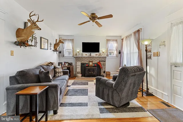 a living room with furniture fireplace and a flat screen tv