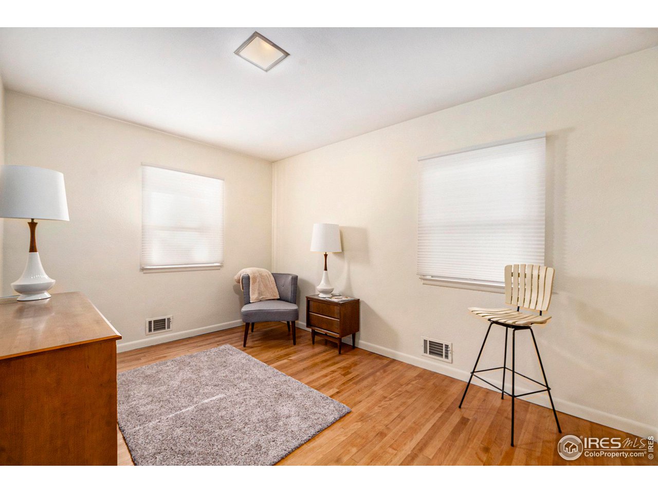 2425 Sunset Lane Greeley, CO 80634 - Photo 11 of 28 a living room with furniture and a wooden floor