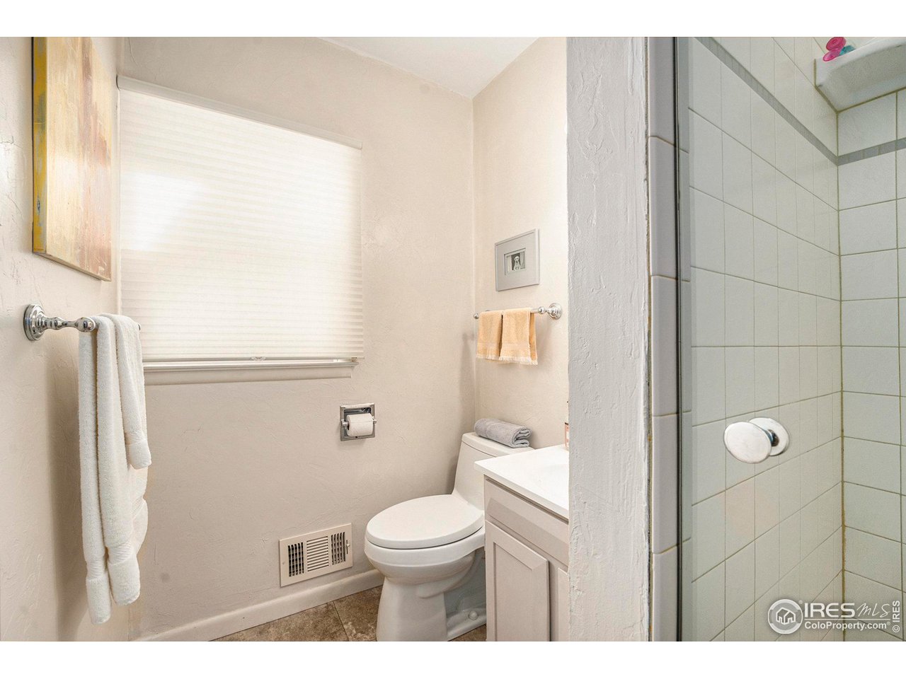 2425 Sunset Lane Greeley, CO 80634 - Photo 14 of 28 a bathroom with a toilet a sink and a mirror