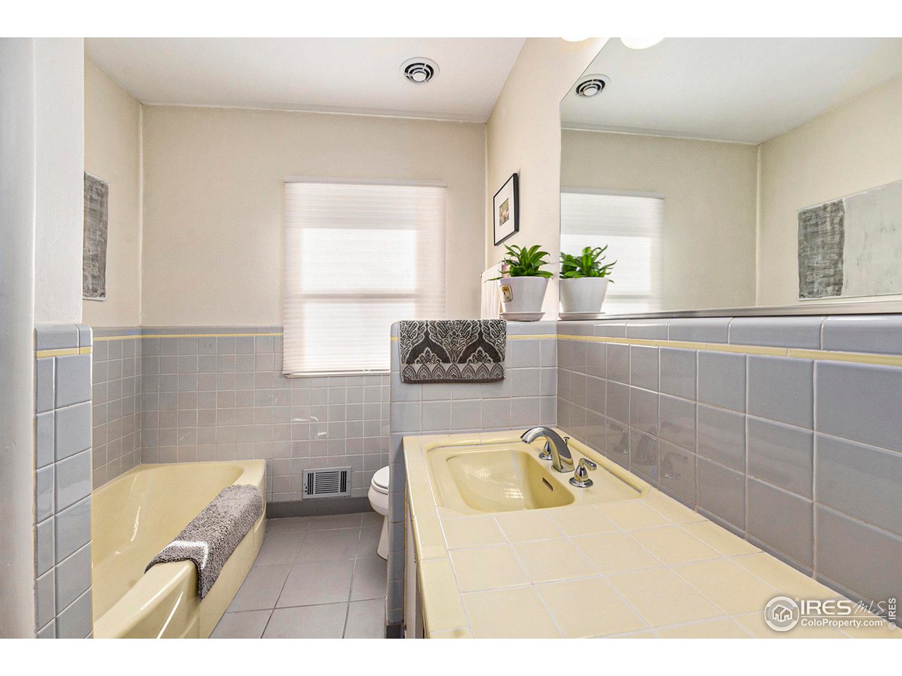 2425 Sunset Lane Greeley, CO 80634 - Photo 15 of 28 a bathroom with a tub sink and mirror