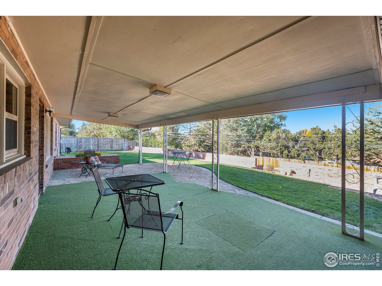 2425 Sunset Lane Greeley, CO 80634 - Photo 17 of 28 a backyard of a house with table and chairs