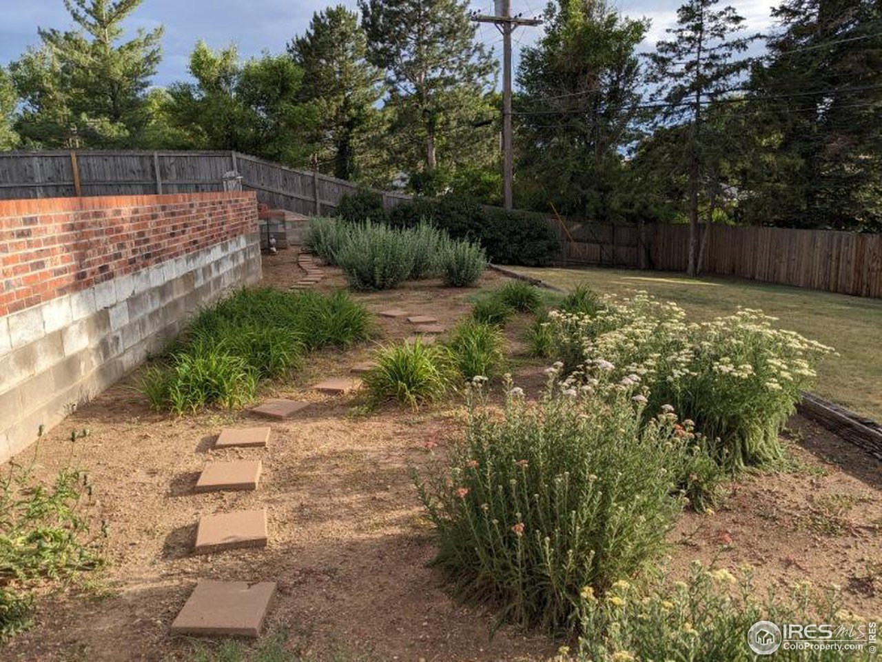 2425 Sunset Lane Greeley, CO 80634 - Photo 27 of 28 a view of backyard with small pool and wooden fence