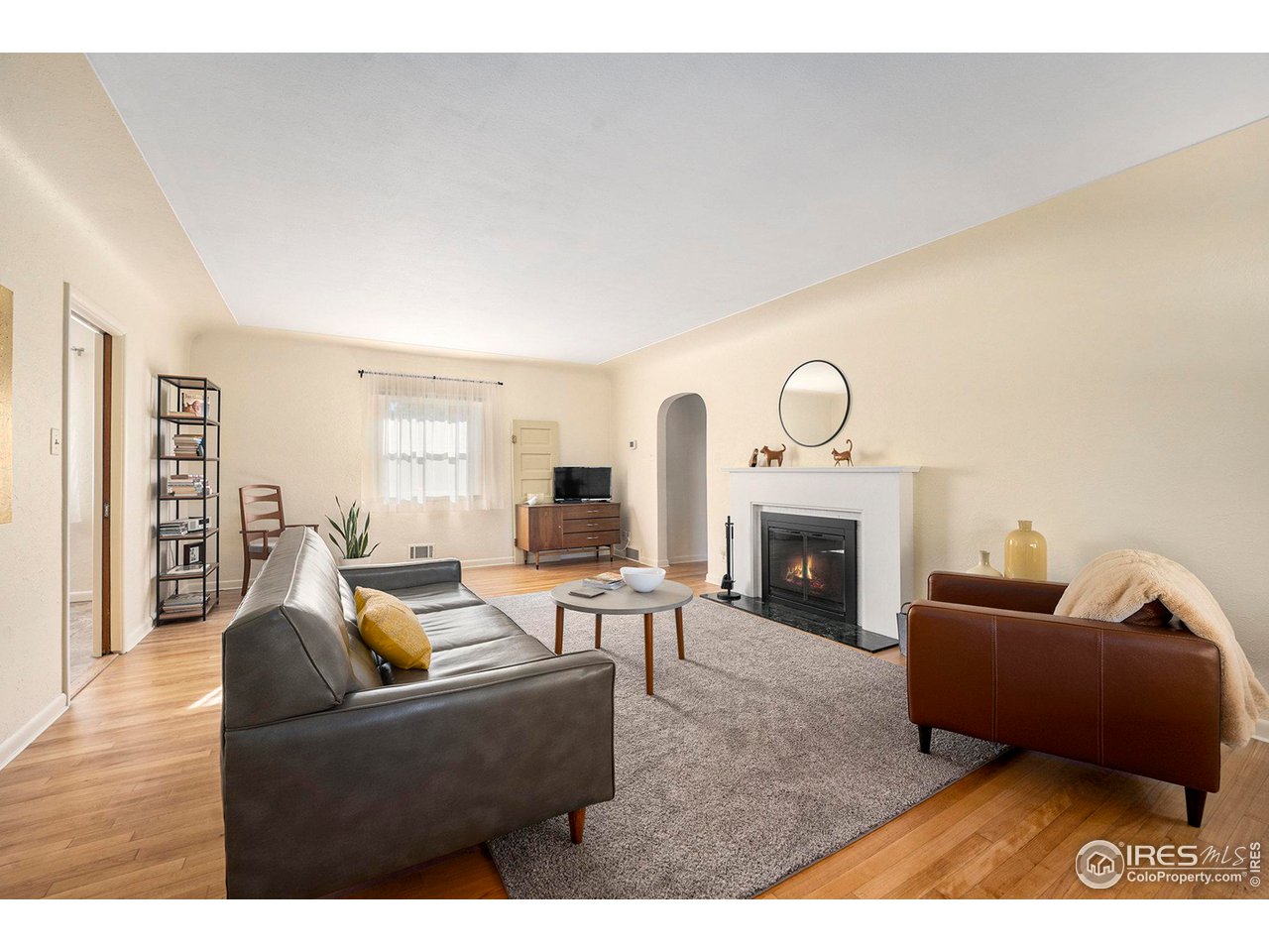 2425 Sunset Lane Greeley, CO 80634 - Photo 5 of 28 a living room with furniture a fireplace and a fireplace