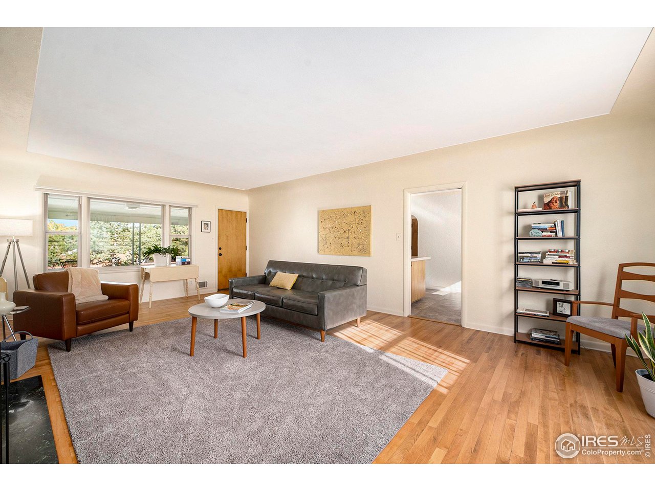 2425 Sunset Lane Greeley, CO 80634 - Photo 6 of 28 a living room with furniture and a wooden floor