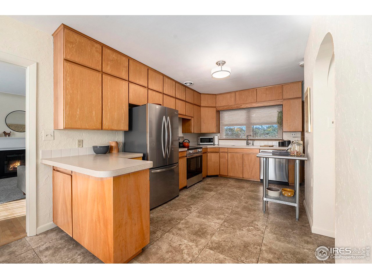 2425 Sunset Lane Greeley, CO 80634 - Photo 7 of 28 a kitchen with stainless steel appliances granite countertop a refrigerator a stove a sink and a microwave