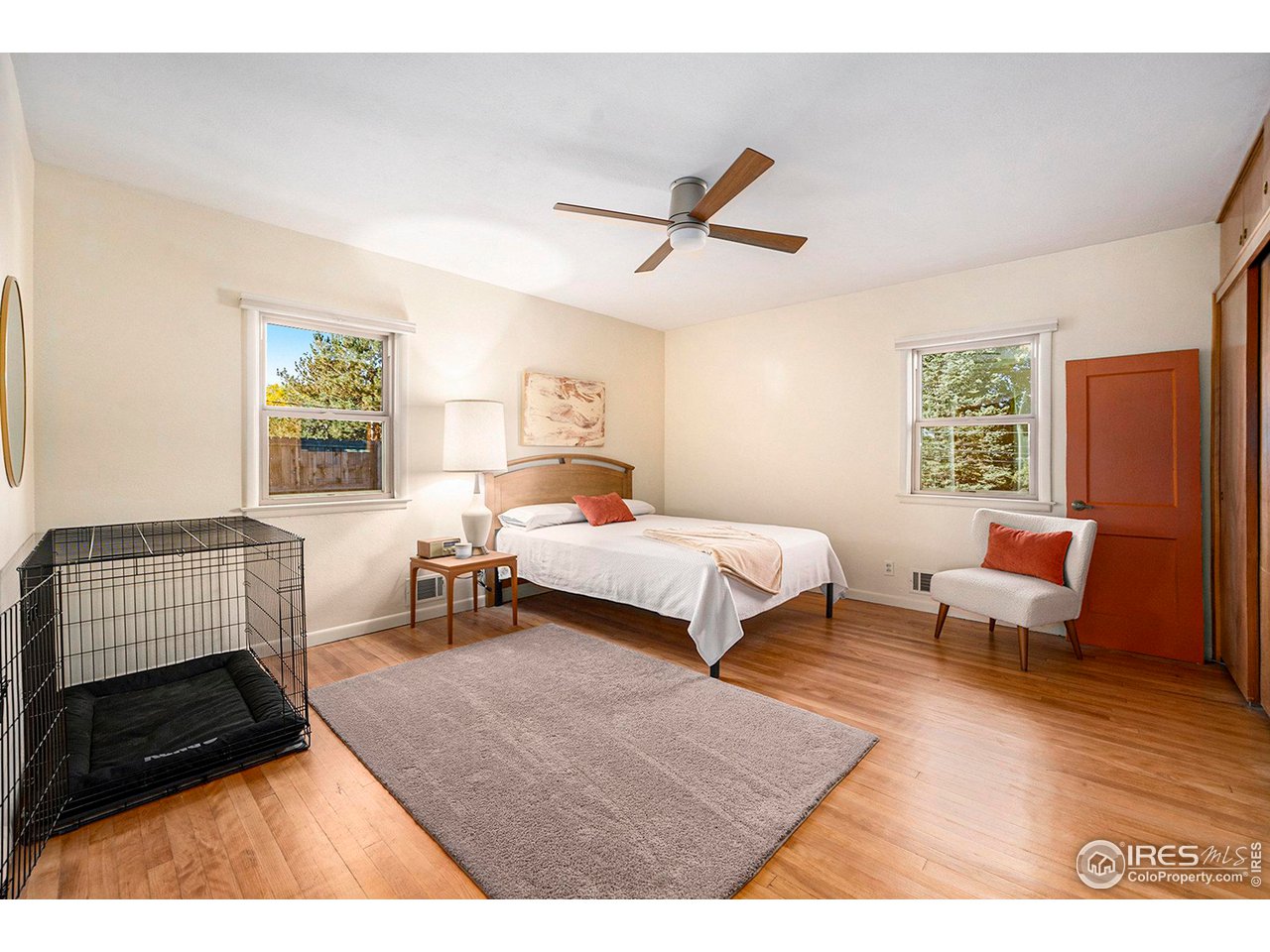 2425 Sunset Lane Greeley, CO 80634 - Photo 9 of 28 a bedroom with a bed a couch and a window