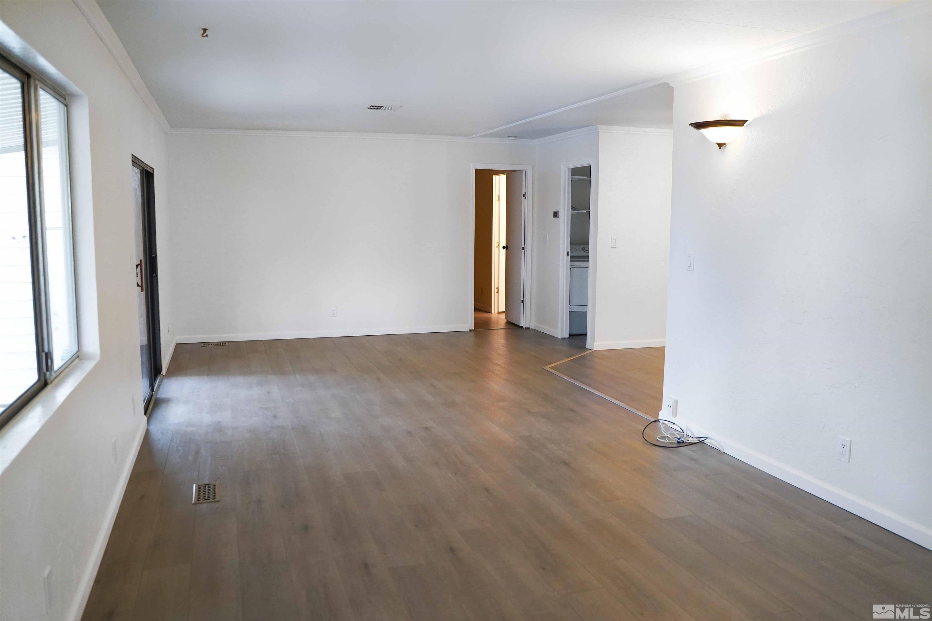 340 Saturn Circle Reno, NV 89521 - Photo 5 of 20 an empty room with wooden floor and windows