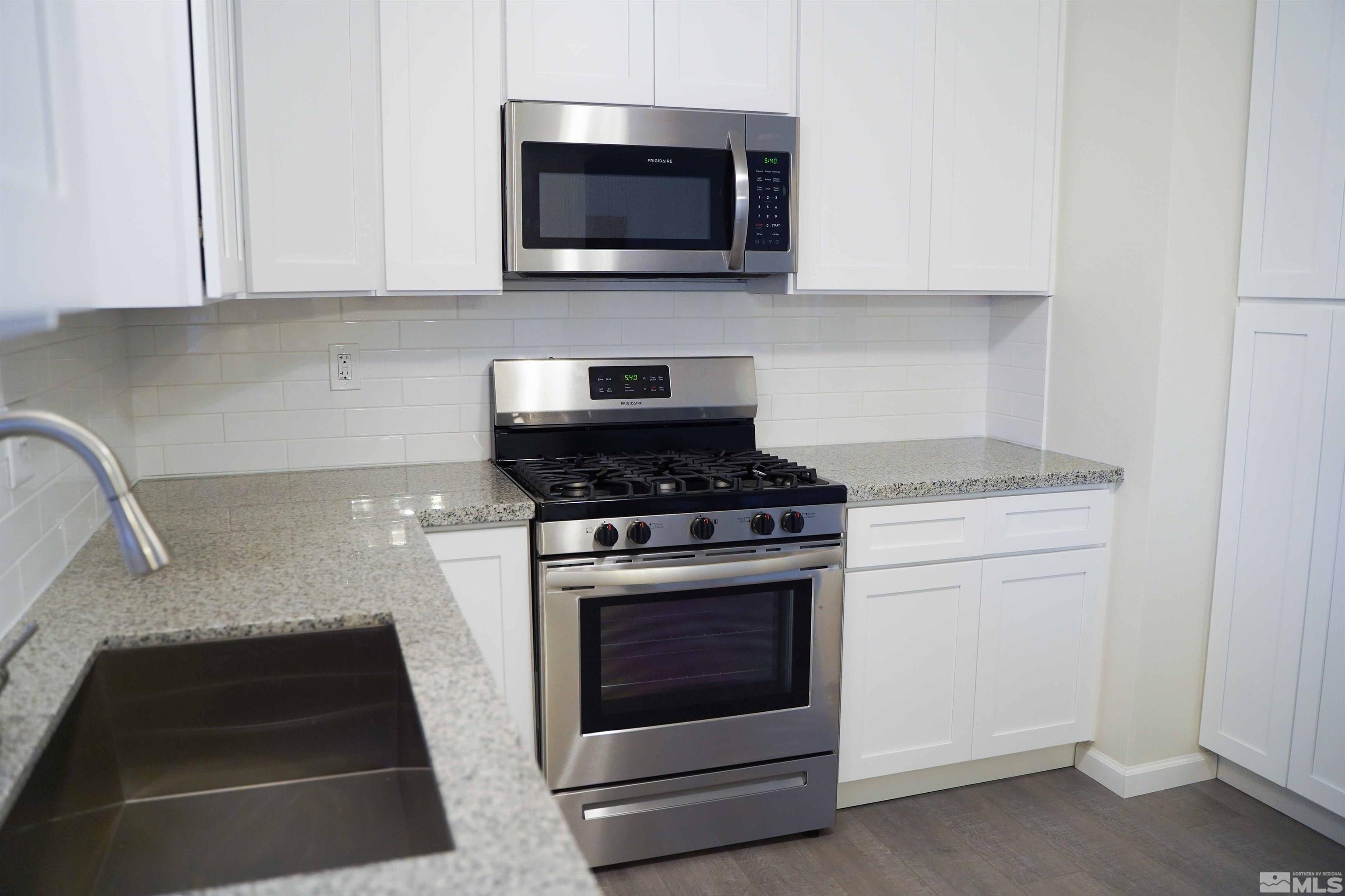 340 Saturn Circle Reno, NV 89521 - Photo 7 of 20 a kitchen with microwave stove and cabinets