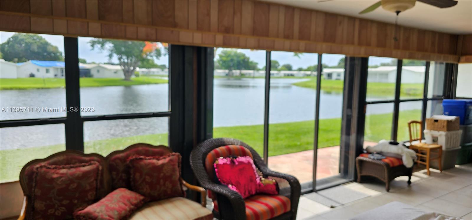 a living room with furniture and a floor to ceiling window