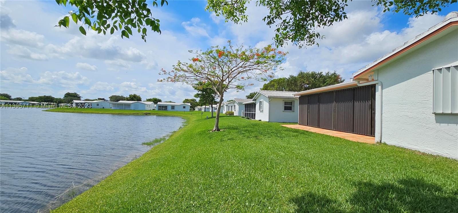 Lauderdale West Plantation Plantation, FL 33322 - Photo 5 of 17 a view of a house with a yard and a lake view
