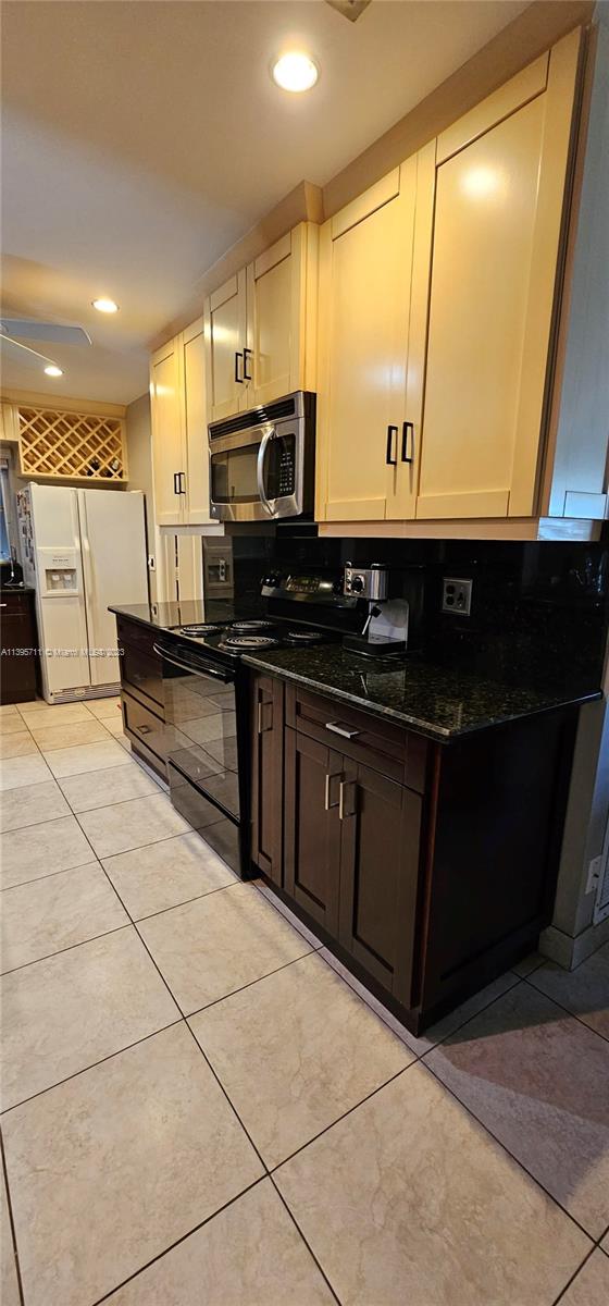 Lauderdale West Plantation Plantation, FL 33322 - Photo 8 of 17 a kitchen with stainless steel appliances a sink and a microwave
