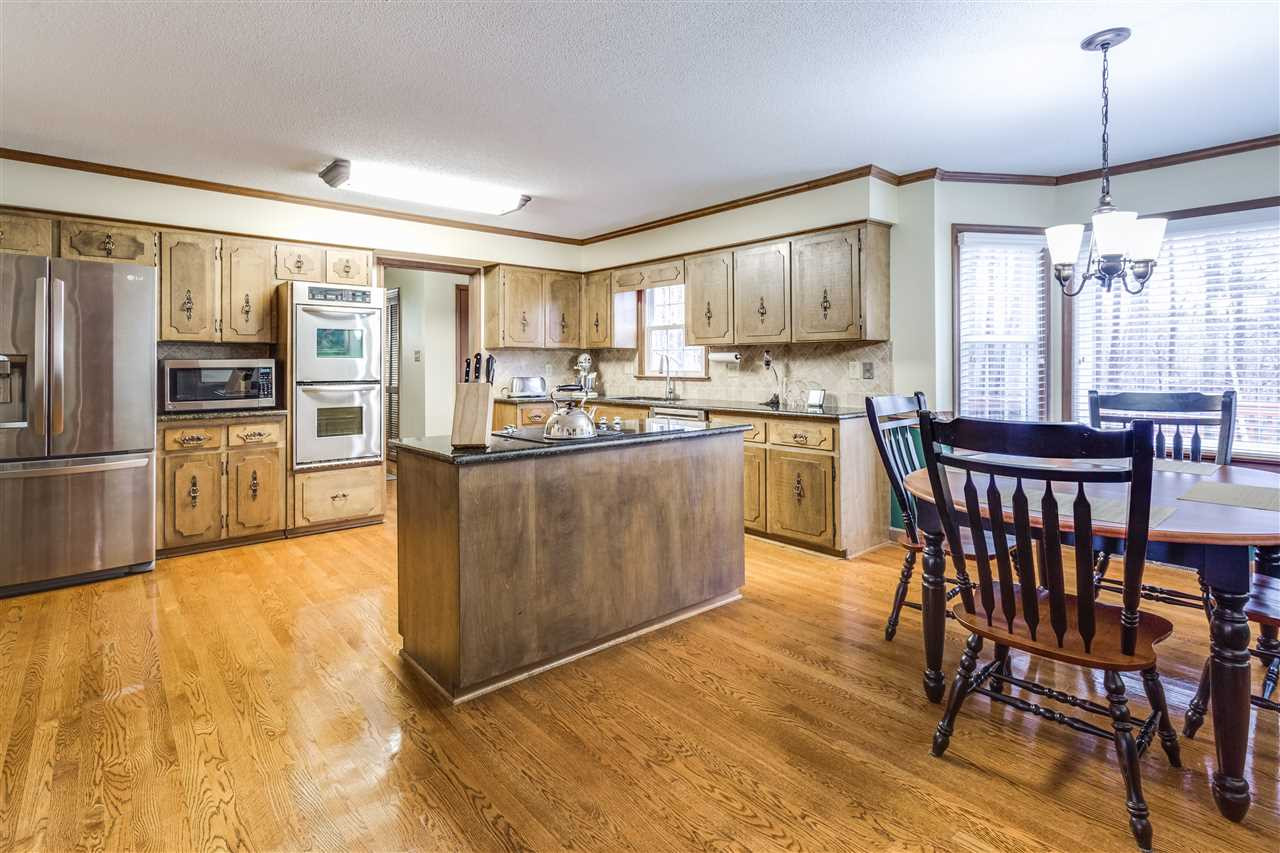 Huge layout with center island and tons of cabinet space. SS appliances and granite complete the kitchen. Kitchen