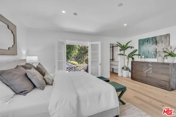 a bedroom with a large bed and a dresser