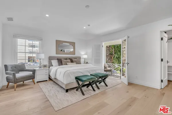 a bedroom with a bed and a couch