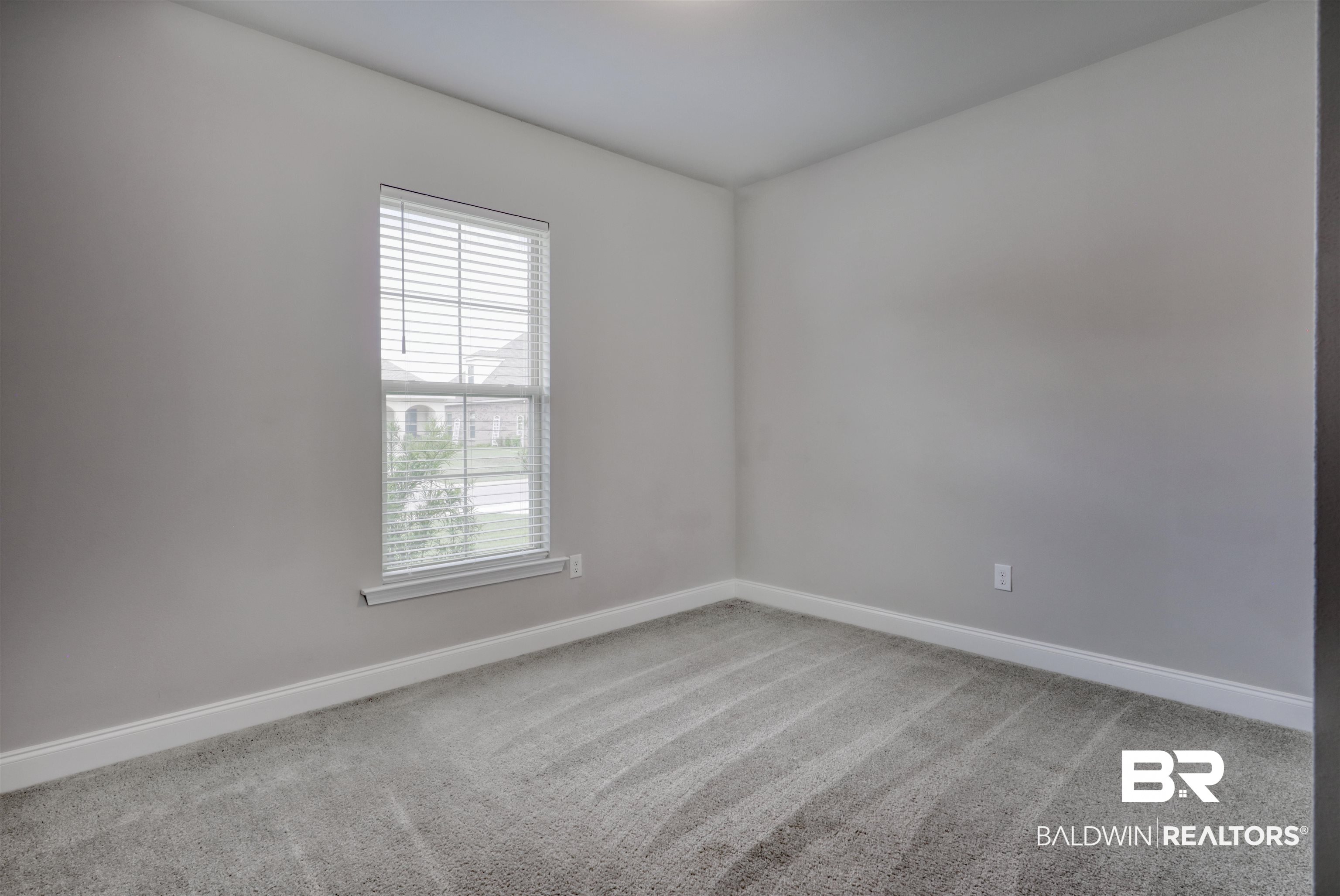987 Gibson Court Foley, AL 36535 - Photo 24 of 34 Carpeted empty room featuring baseboards