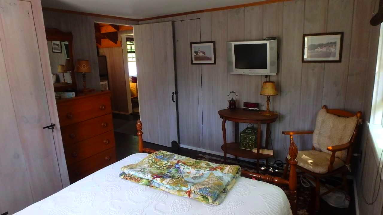 60 Designers Road, Unit C Wellfleet, MA 02667 - Photo 13 of 18 a bedroom with furniture and a wooden floor