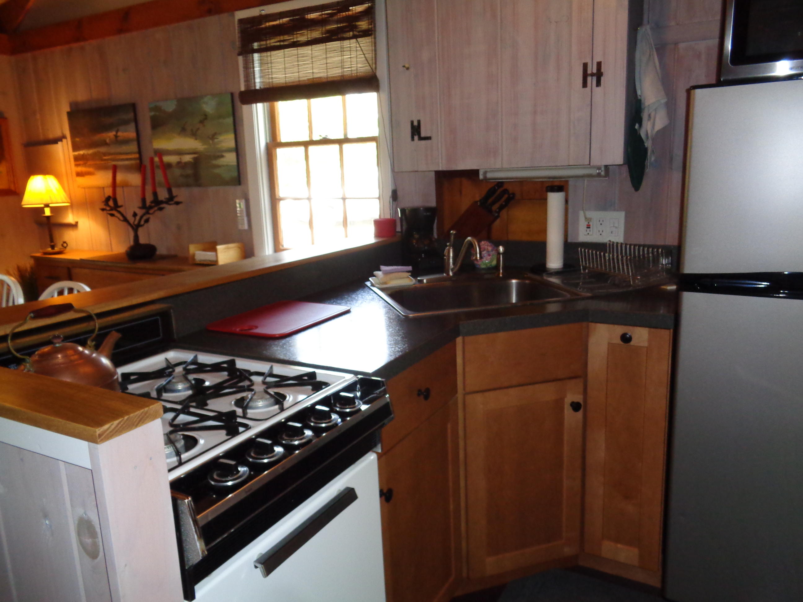 60 Designers Road, Unit C Wellfleet, MA 02667 - Photo 8 of 18 a kitchen with a stove and a window