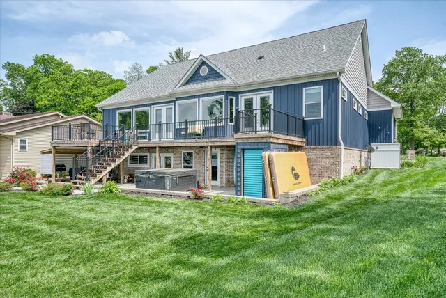 a front view of a house with garden and lake view