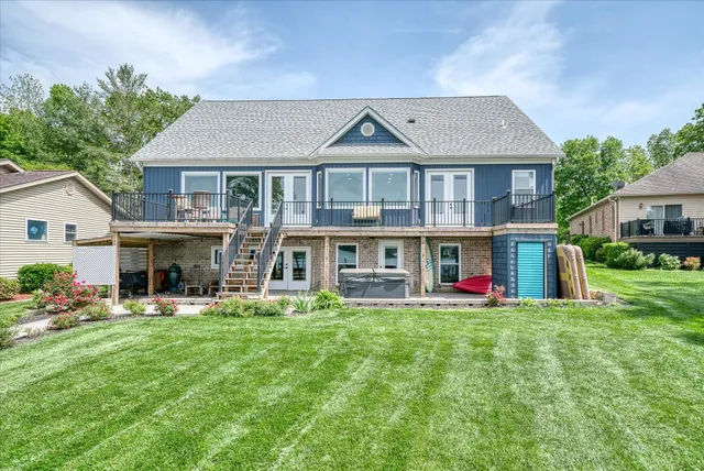 a front view of a house with a garden and plants