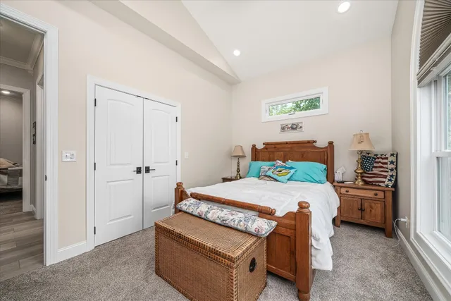 a kitchen with stainless steel appliances kitchen island granite countertop a table chairs refrigerator and microwave