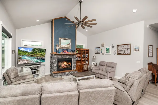 a bathroom with a granite countertop sink a mirror and a shower