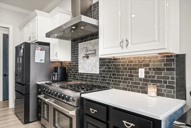 a view of kitchen and kitchen with stainless steel appliances granite countertop sink stove and cabinets