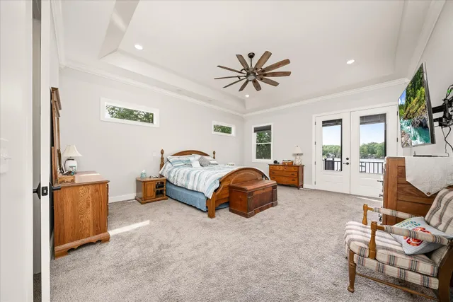 an aerial view of a residential houses with outdoor space and lake view