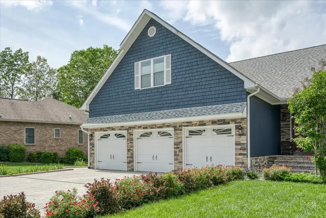 a view of a house with garage and yard