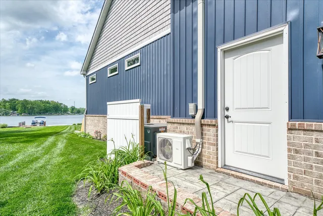 a view of a house with a big yard and large trees