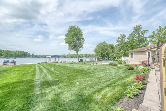 a view of a house with a yard and sitting area