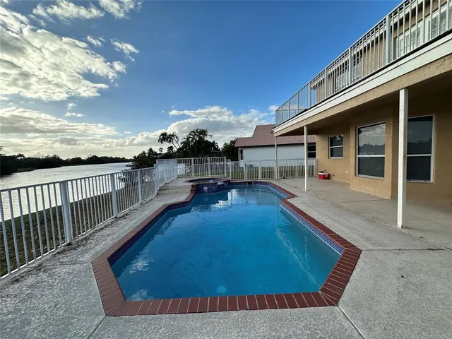 a view of a house with swimming pool in front of it