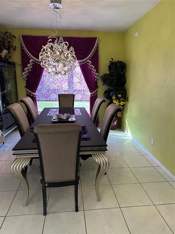 a workspace with furniture and a chandelier