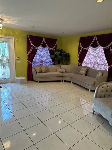 a living room with furniture and a rug