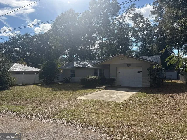 a front view of house with yard and trees