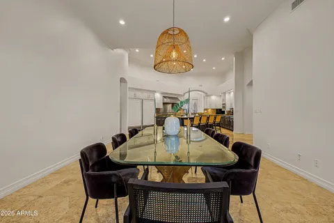 a living room with stainless steel appliances kitchen island granite countertop furniture and a refrigerator