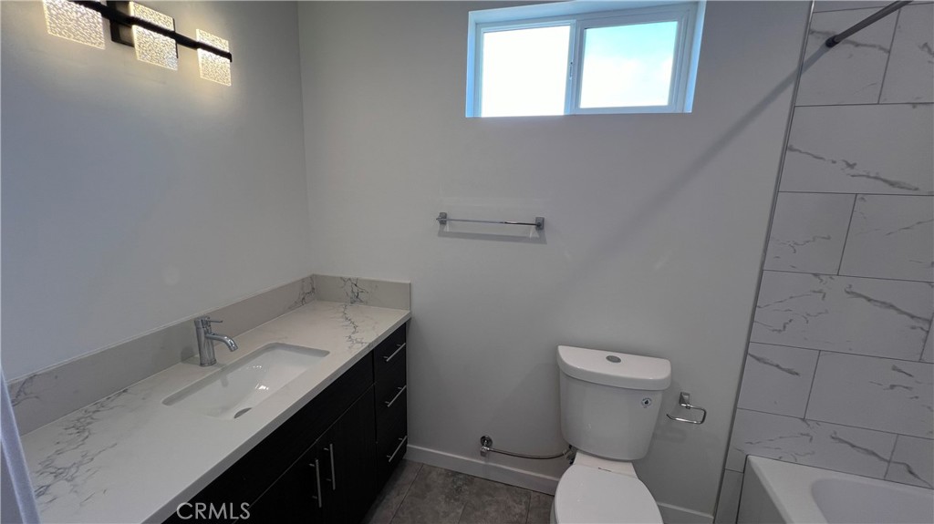 955 North Acacia Avenue, Unit B Compton, CA 90220 - Photo 13 of 15 a bathroom with a sink toilet and vanity