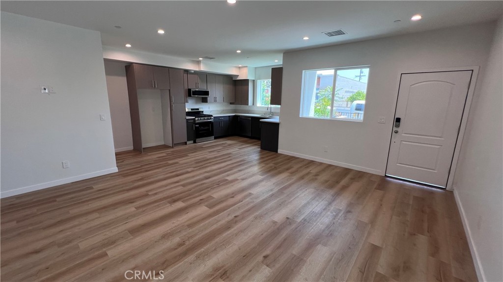 955 North Acacia Avenue, Unit B Compton, CA 90220 - Photo 2 of 15 a view of kitchen with refrigerator and wooden floor