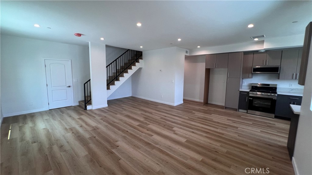 955 North Acacia Avenue, Unit B Compton, CA 90220 - Photo 3 of 15 a view of kitchen and empty room with wooden floor