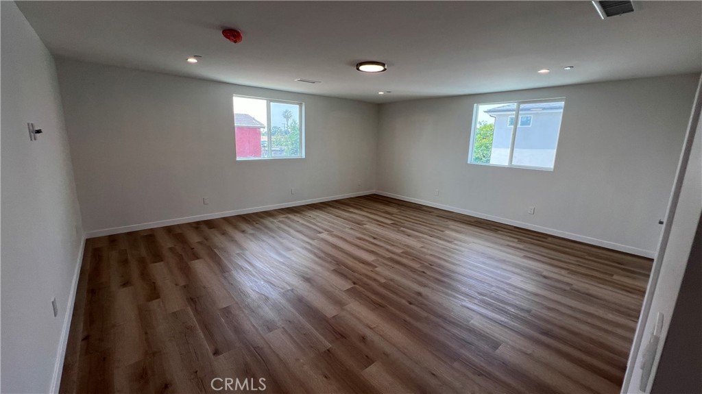 955 North Acacia Avenue, Unit B Compton, CA 90220 - Photo 7 of 15 an empty room with wooden floor and windows
