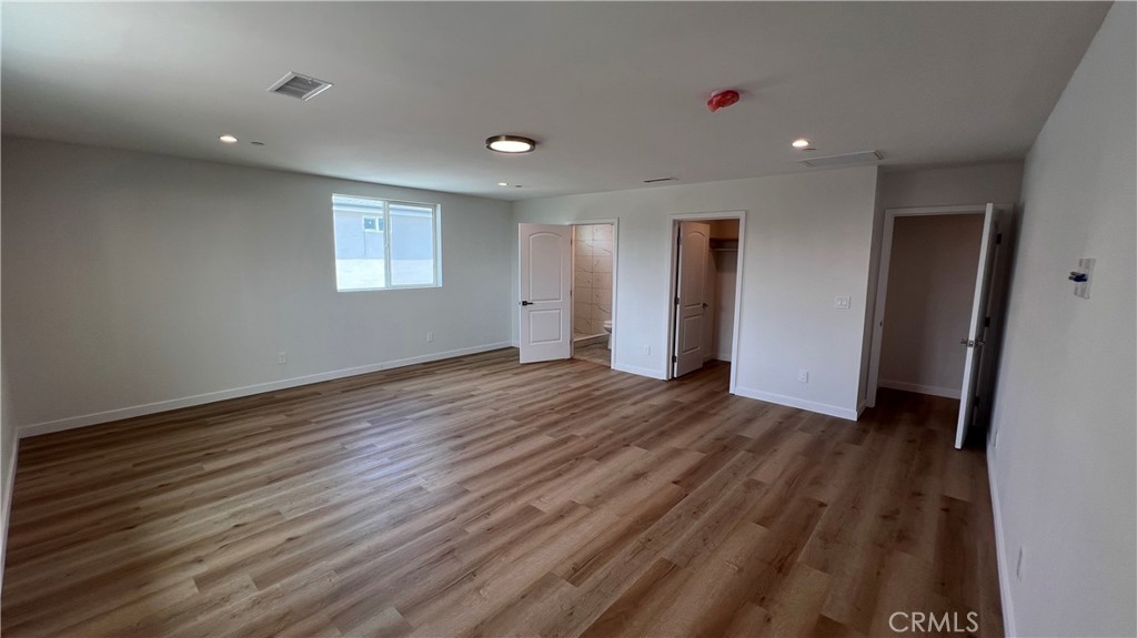 955 North Acacia Avenue, Unit B Compton, CA 90220 - Photo 8 of 15 an empty room with wooden floor and windows