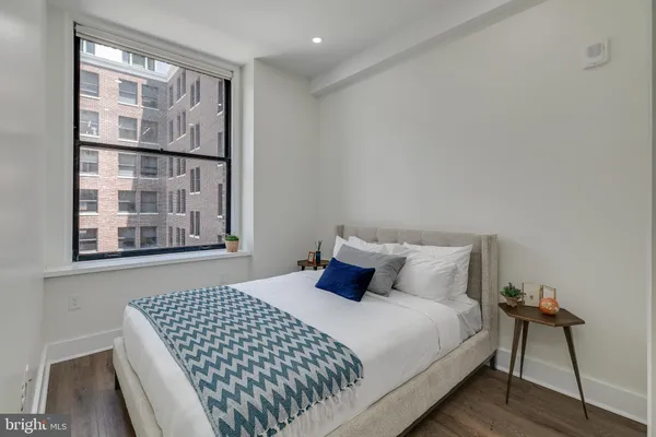 a bedroom with a bed and window