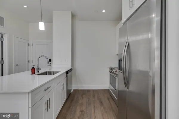 a kitchen with a sink and refrigerator