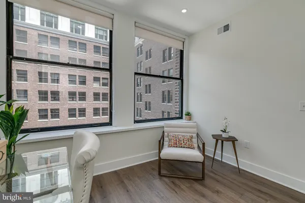 a view of a livingroom with furniture and workspace
